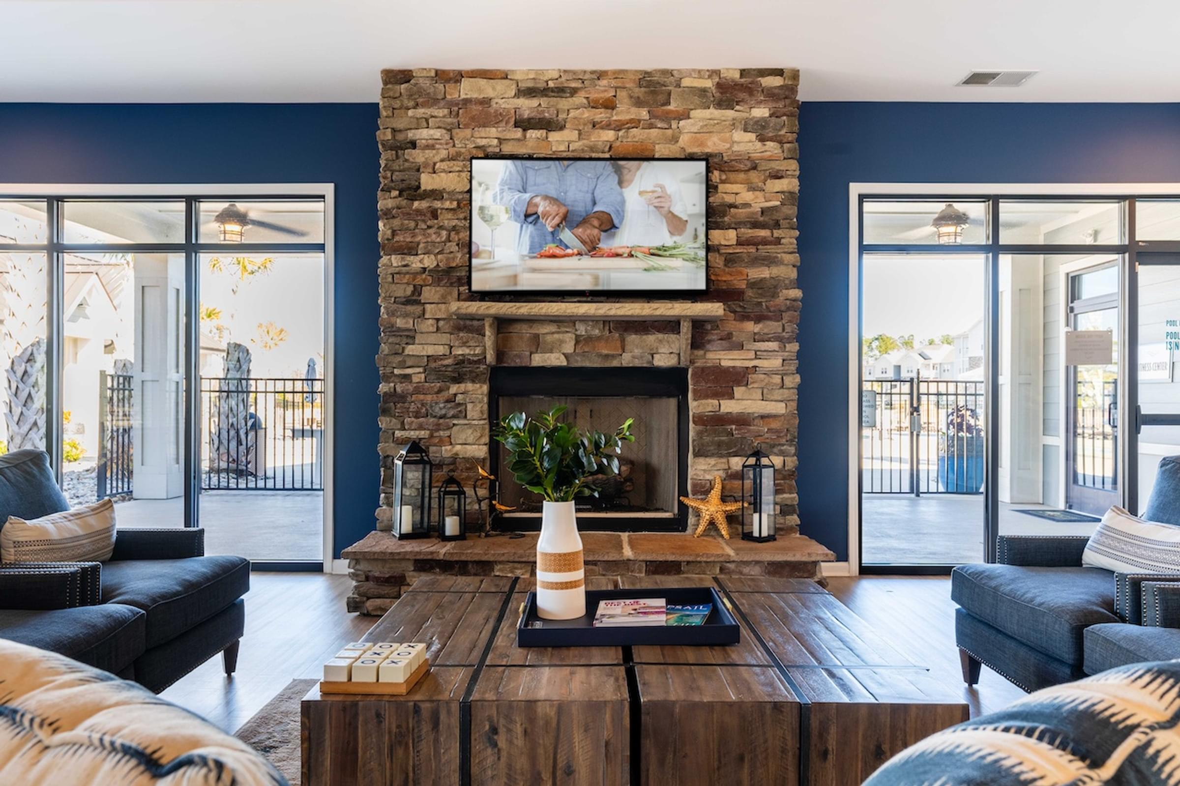 a living room with blue walls and a stone fireplace