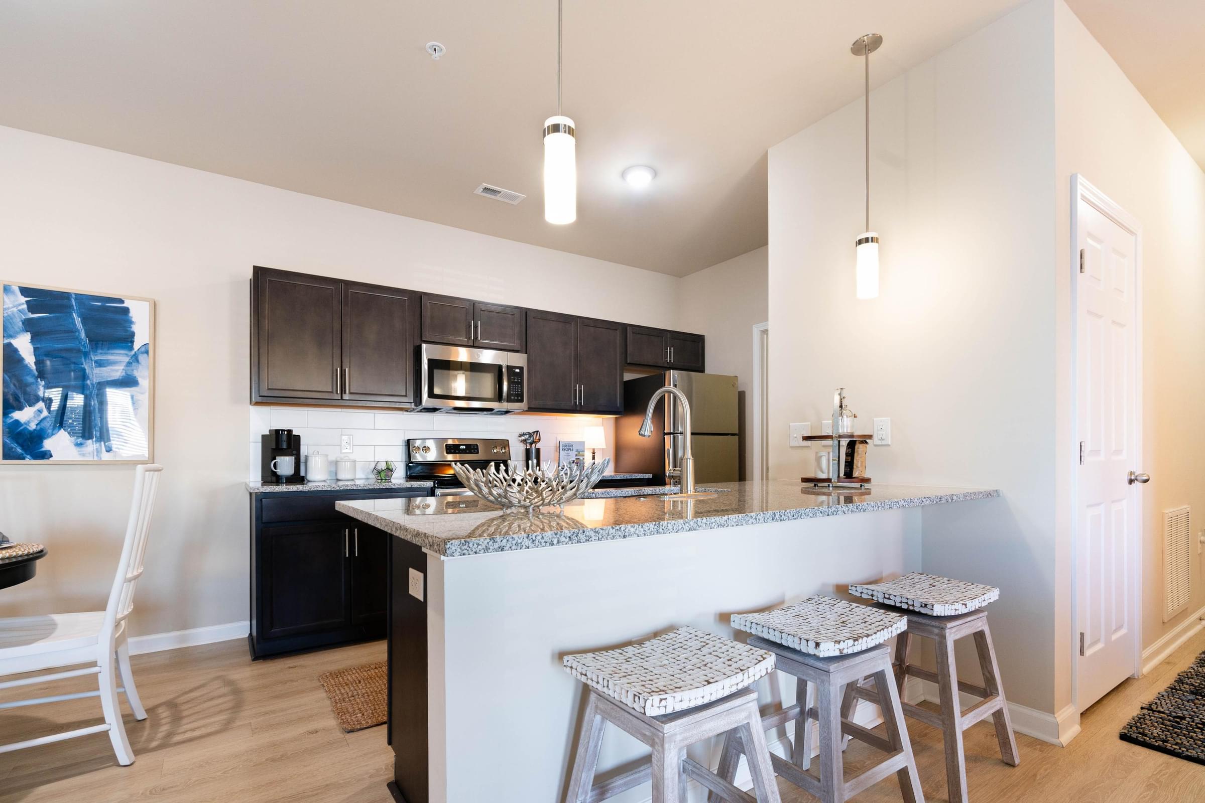 Custom Designed Kitchen With Stainless Steel Appliances And Granite Countertops