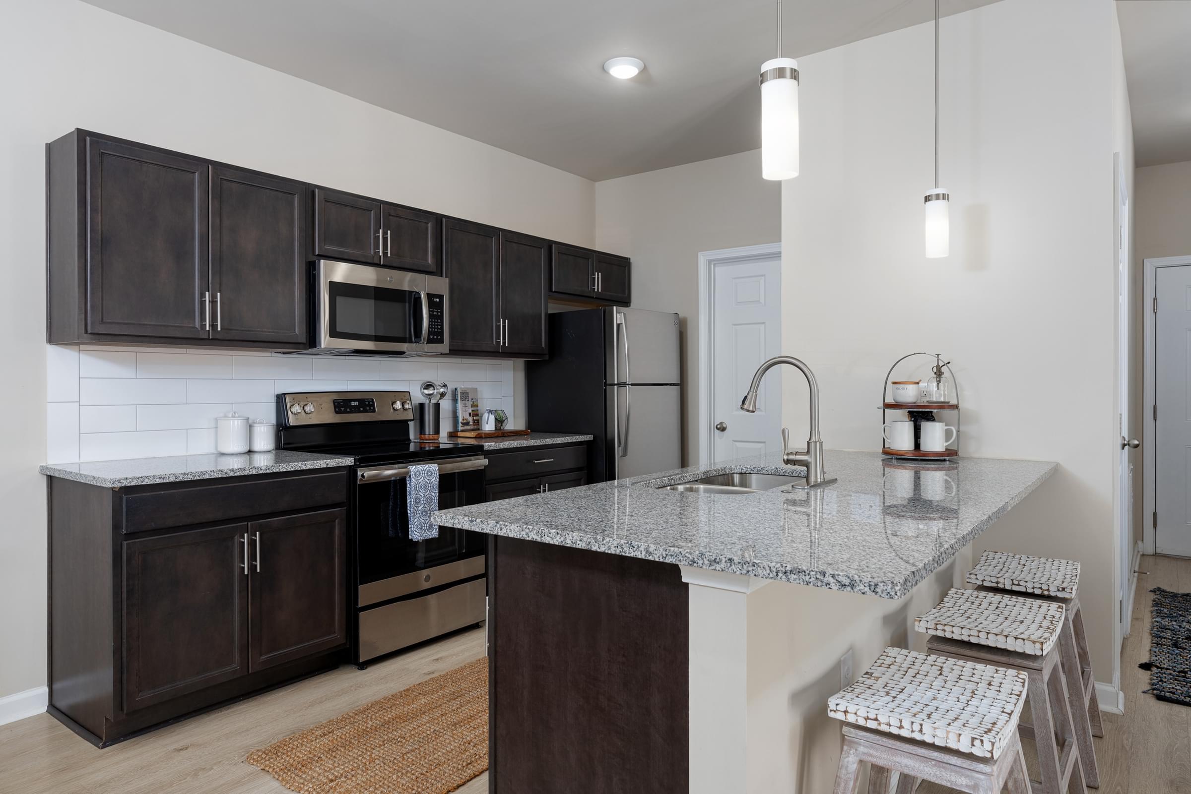 Custom Designed Kitchen With Stainless Steel Appliances And Granite Countertops