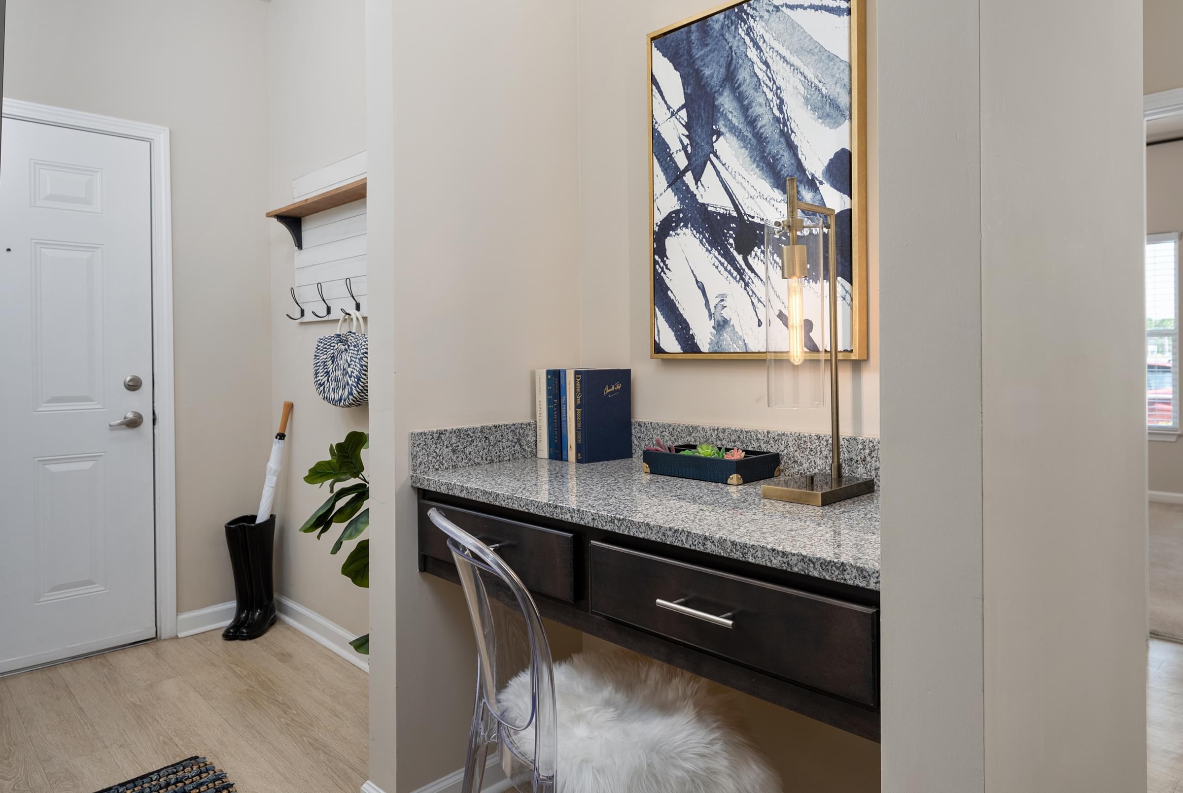 A kitchen with a white chair and a painting on the wall.