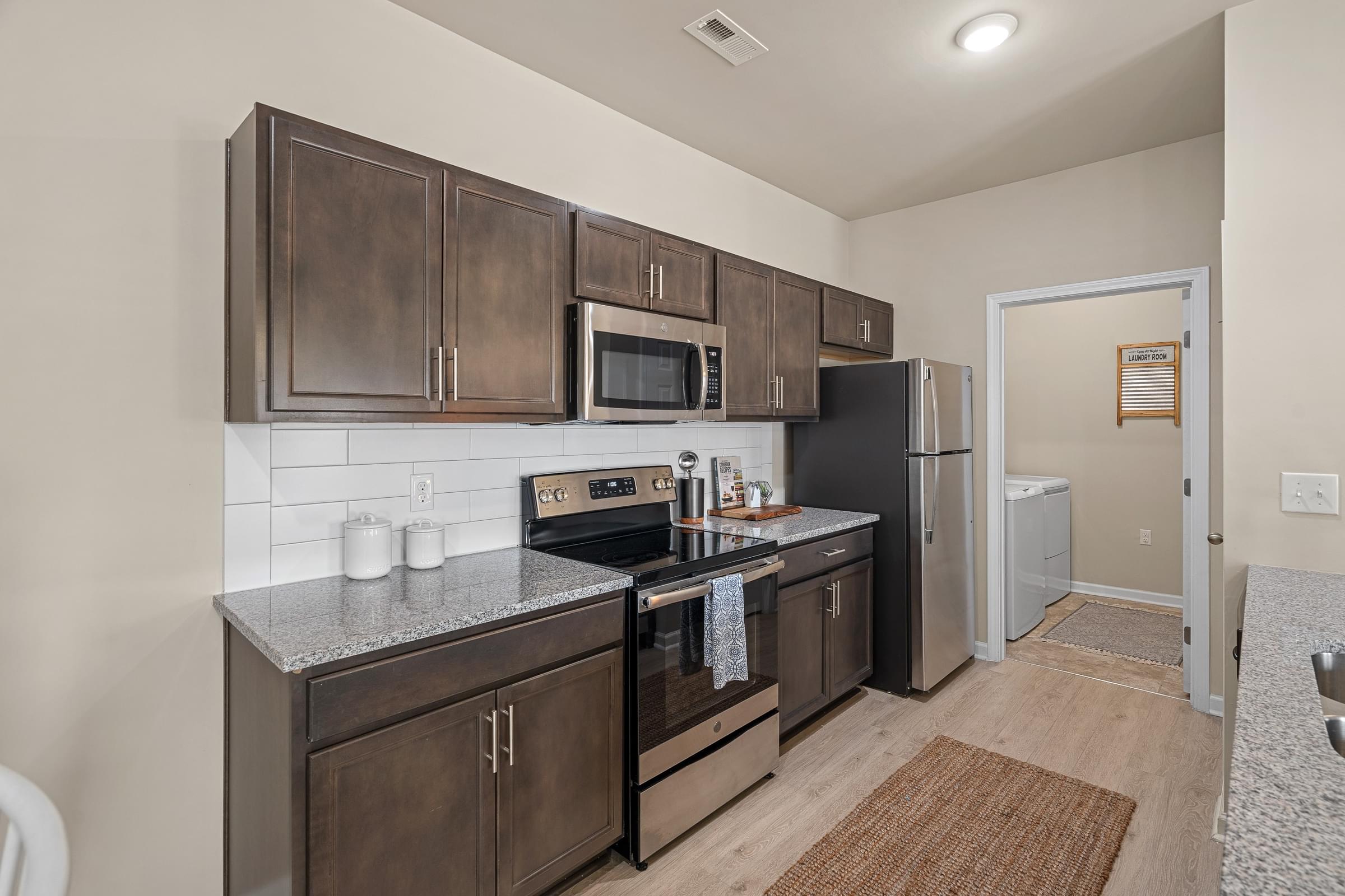 Custom Designed Kitchen With Stainless Steel Appliances And Granite Countertops