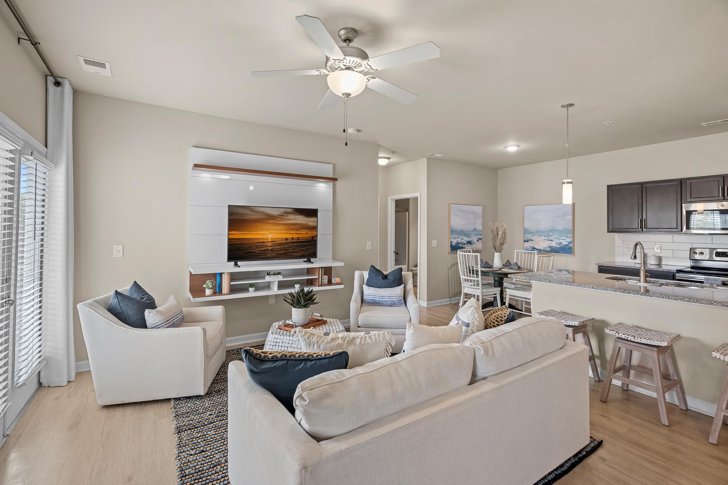 A living room with a white couch and a television.