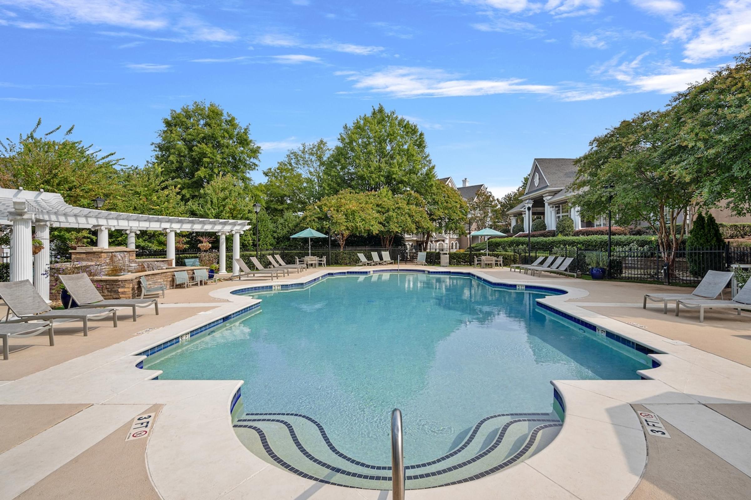 Resort-Style Swimming Pool with Expansive Sundeck and Water Feature