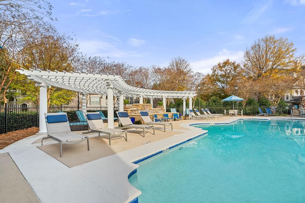 Spacious poolside sundeck with lounge chairs at Hawthorne at the Carlyle in Greenville, SC
