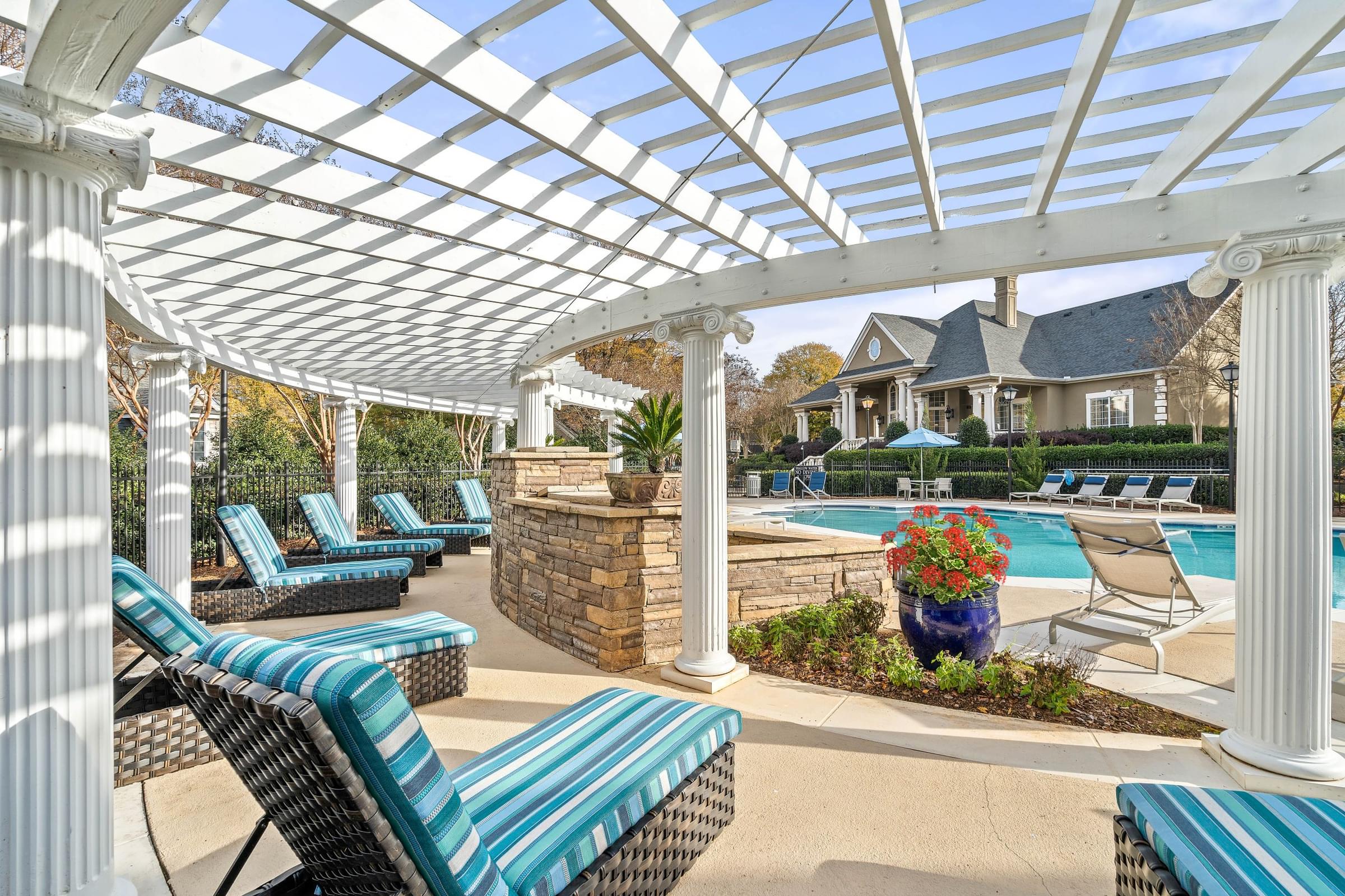 Spacious poolside sundeck with lounge chairs at Hawthorne at the Carlyle in Greenville, SC