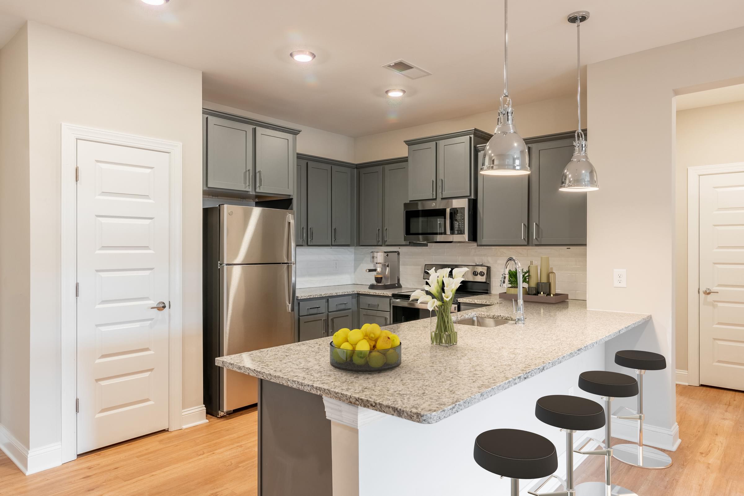A kitchen with a granite countertop and a refrigerator