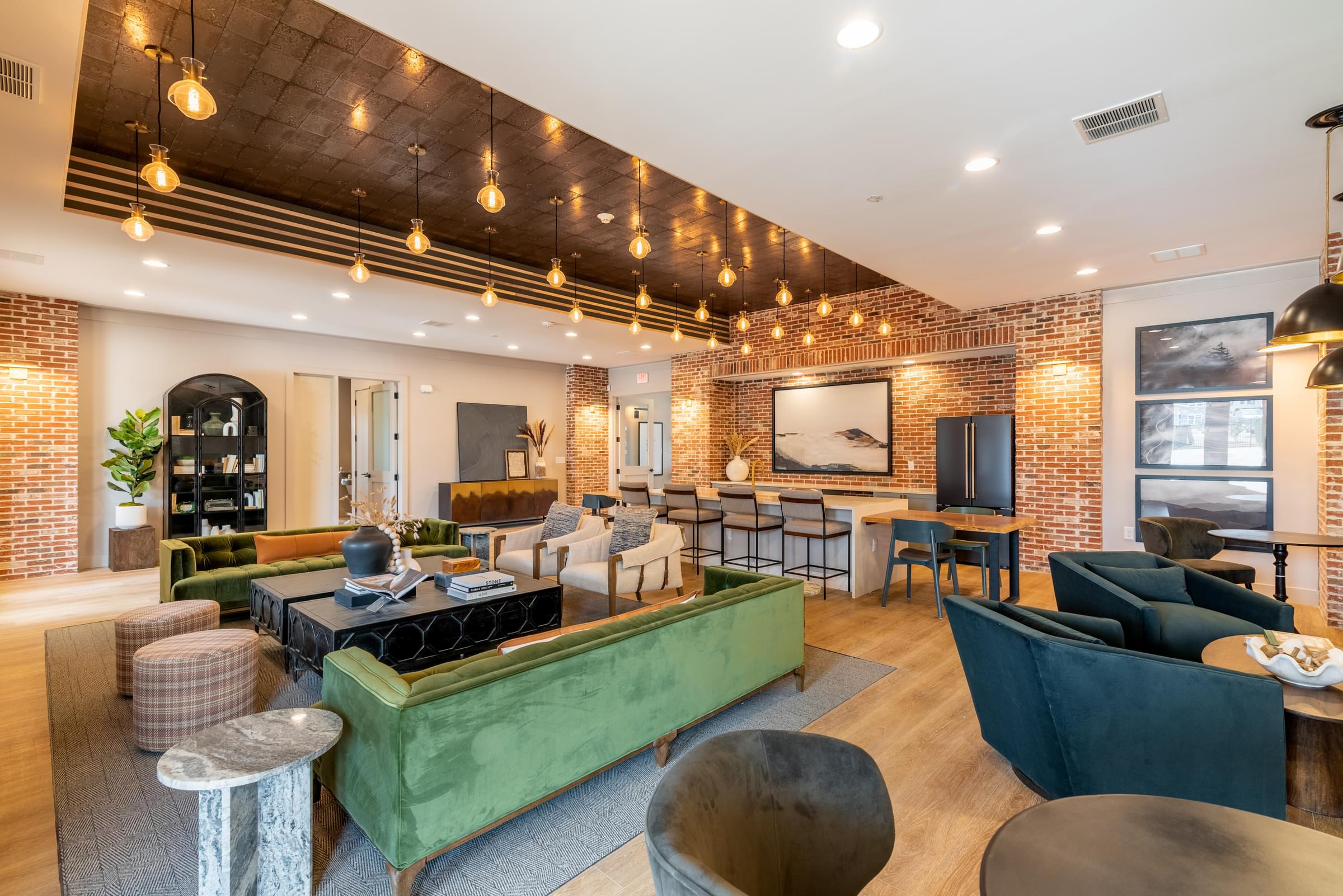 A living room with a brown couch and a chess board on the coffee table