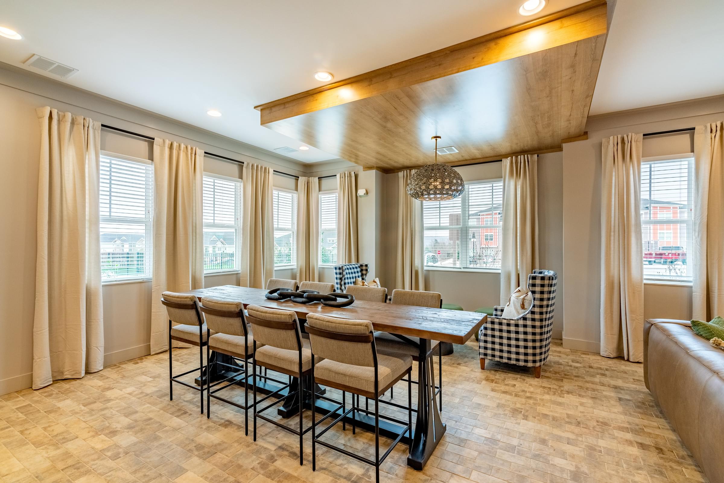 A dining room with a wooden table and chairs