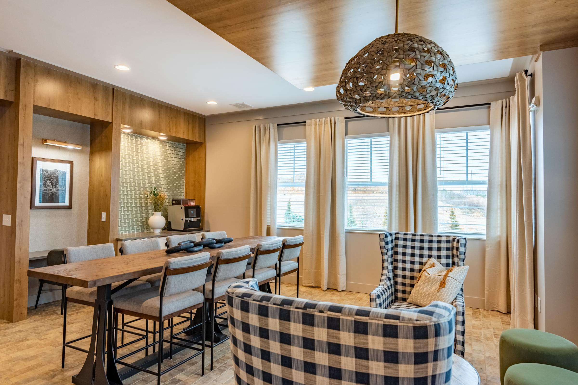 A dining room with a checkered chair and a chandelier