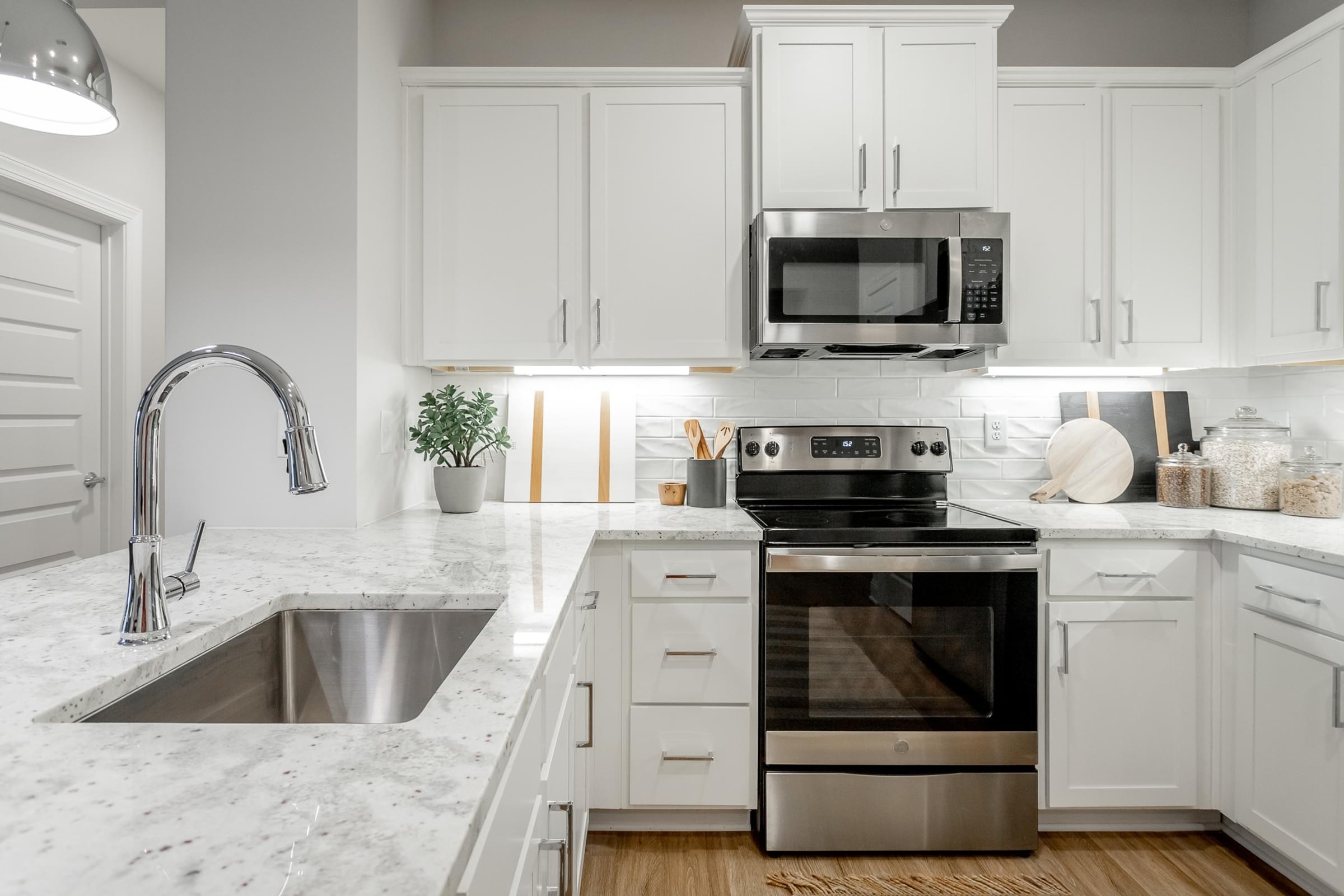 Modern Kitchens with Designer Tile Backsplash and Granite Countertops Throughout