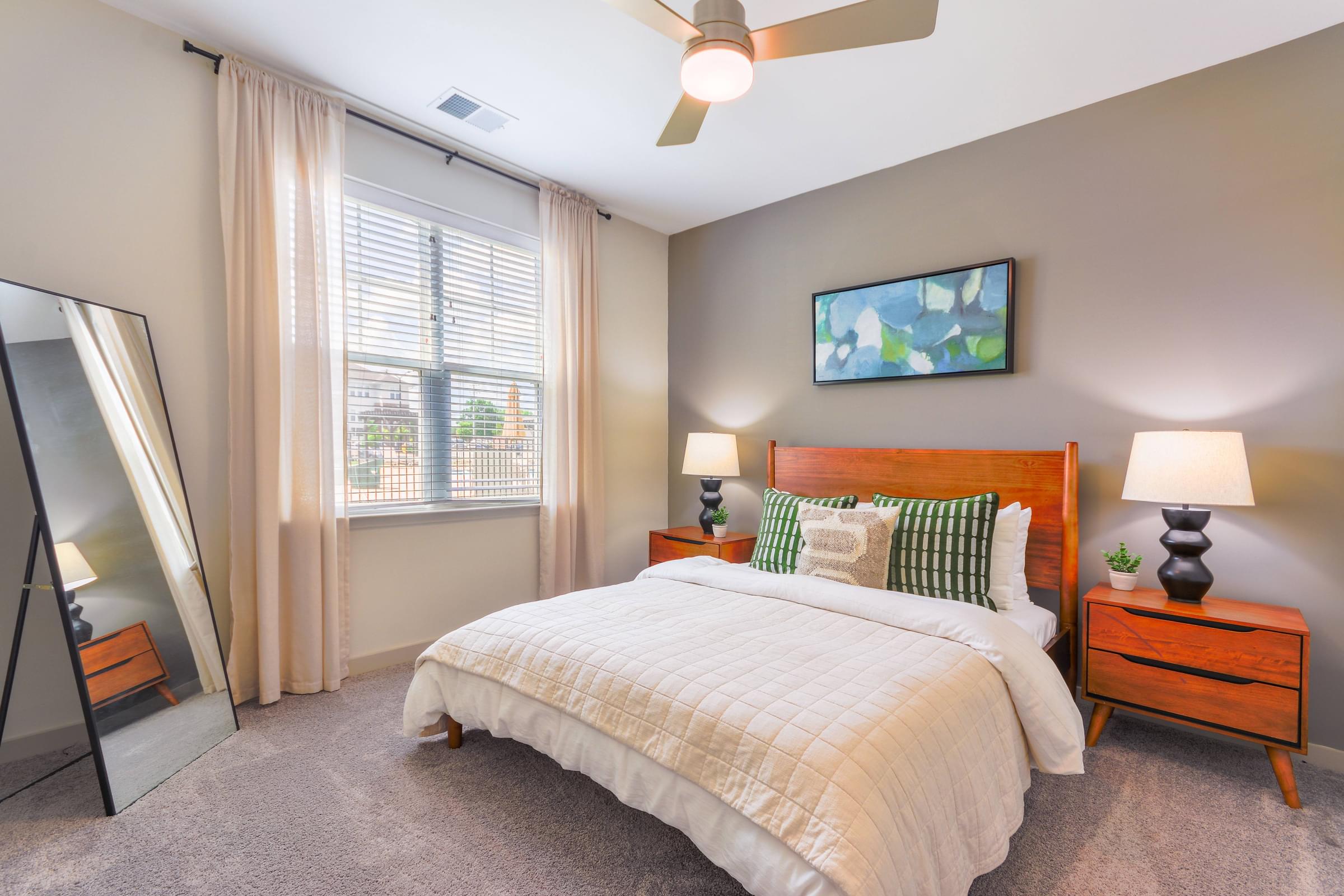 a bedroom with a bed and a large window