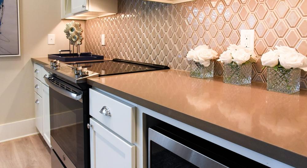 Kitchen features under-cabinet lighting and designer backsplash