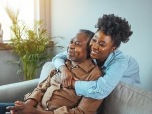 Adult daughter visits senior father in assisted living home