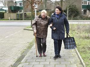 Caregiver Helping Elderly Woman