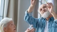 Elderly Couple Changing Lightbulb