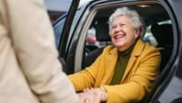 Elderly Lady Getting Out of a Car