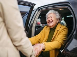 Elderly Lady Getting Out of a Car