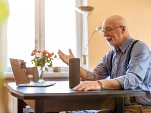 Elderly Man Using Voice Assistant