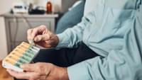Elderly Man Using a Pill Organiser