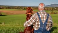 Elderly Man with a Dog in the Countryside