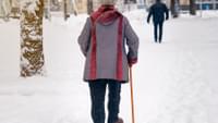 Elderly Person Walking in the Snow