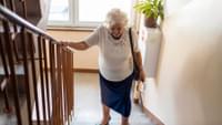 Elderly Woman Climbing Stairs