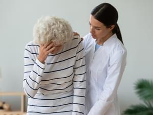 Elderly Woman Holding Her Head