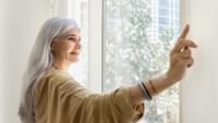 Elderly Woman Opening the Curtains