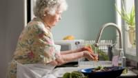 Elderly Woman Washing Vegetables