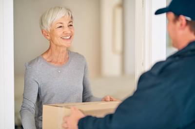 Elderly woman recieving parcel