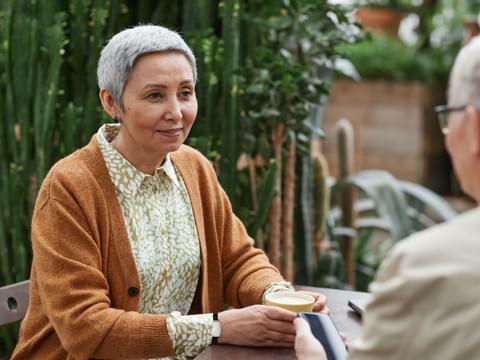 Lady Sat In Garden Wearing SureSafe FallSafe Fall Alarm