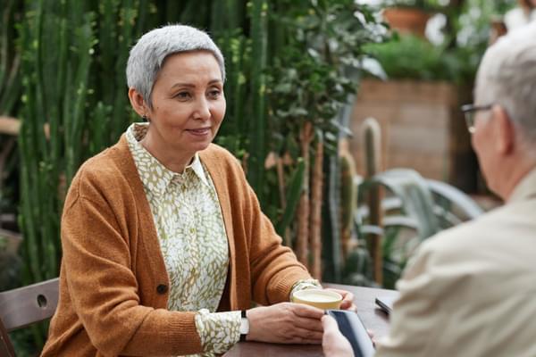 Lady Sat In Garden Wearing SureSafe FallSafe Fall Alarm