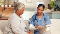 Nurse Giving Advice to Elderly Woman