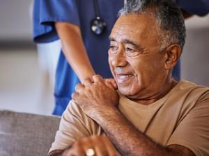 Nurse giving elderly man support