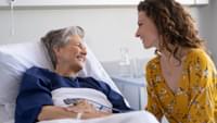 Young Woman Visiting Elderly Woman in Hospital