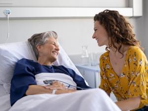 Young Woman Visiting Elderly Woman in Hospital