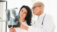 Doctor showing x ray lungs photo to female patient 2021 12 09 20 04 37 utc