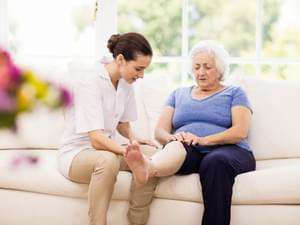 Physiotherapist taking care of elderly patient