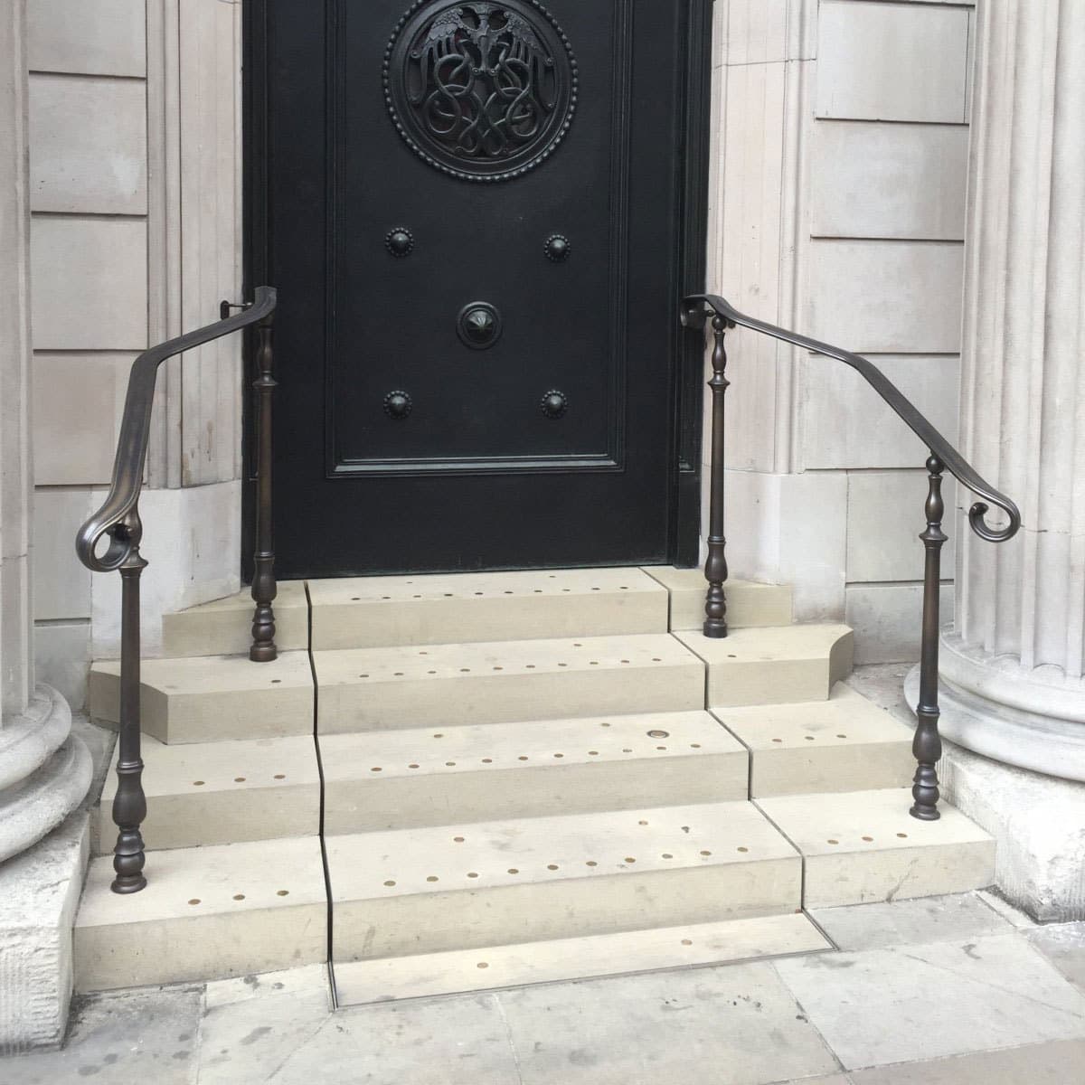 4 stone clad steps at the front door of the bank of england hiding a wheelchair lift for disabled access