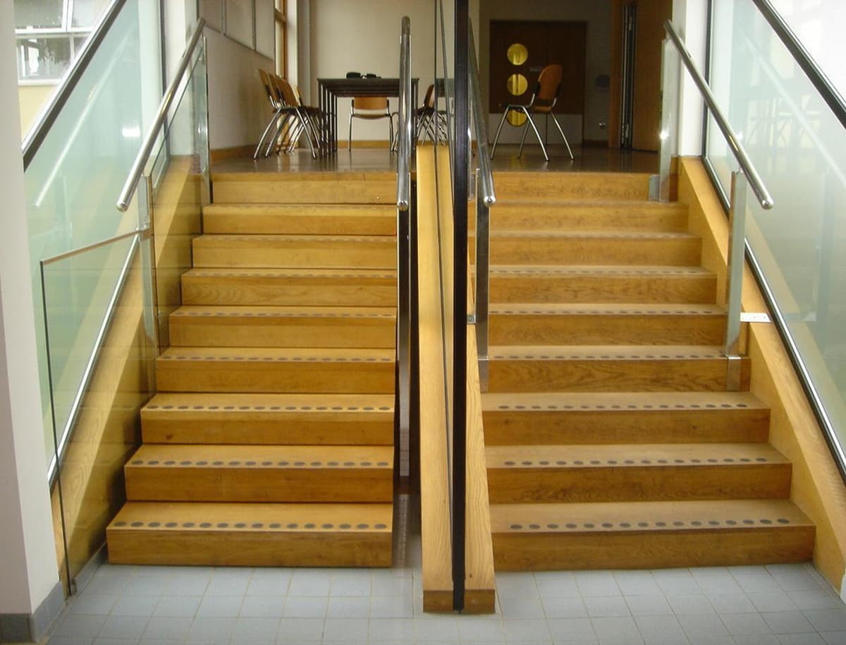 photograph of a large set of wooden steps with stairs out hiding an invisible part m lift