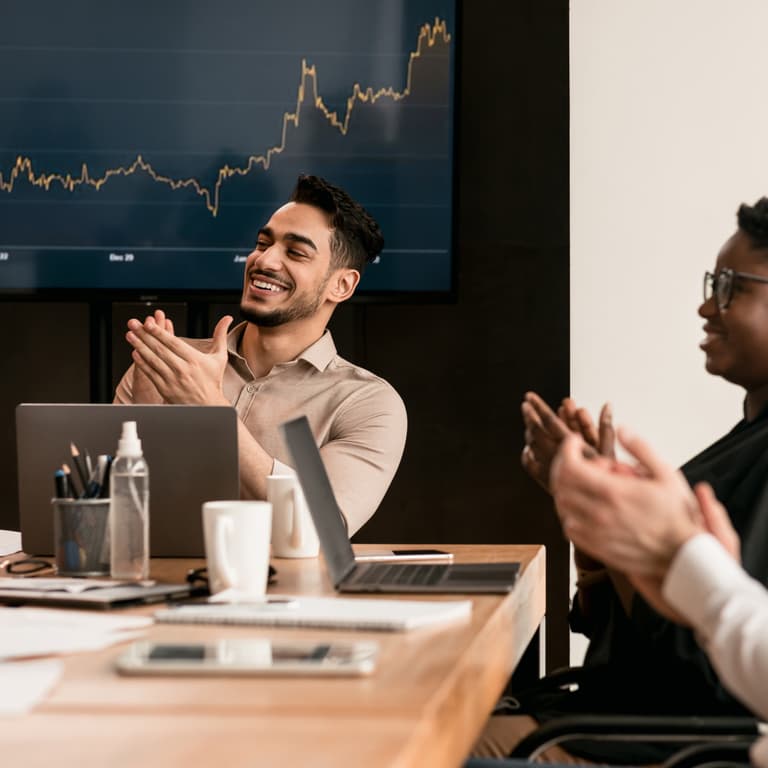 People in boardroom clapping