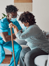 Healthcare worker supports a patient