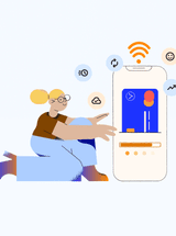 Person kneels in front of a mobile device; a digital payment type is shown on the screen