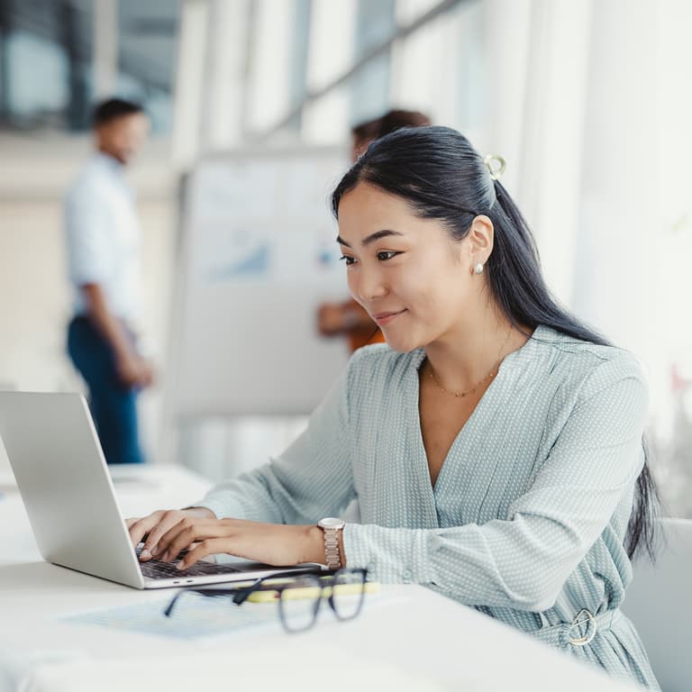 Business professional sitting in front of a laptop