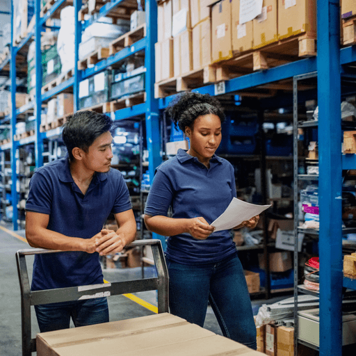 Two colleagues walk through a wholesale distribution warehouse