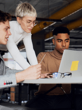 EIPP accelerates AP invoice approval workflows: three people sit around a table, looking at a laptop