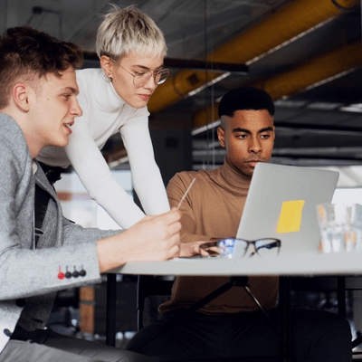 EIPP accelerates AP invoice approval workflows: three people sit around a table, looking at a laptop