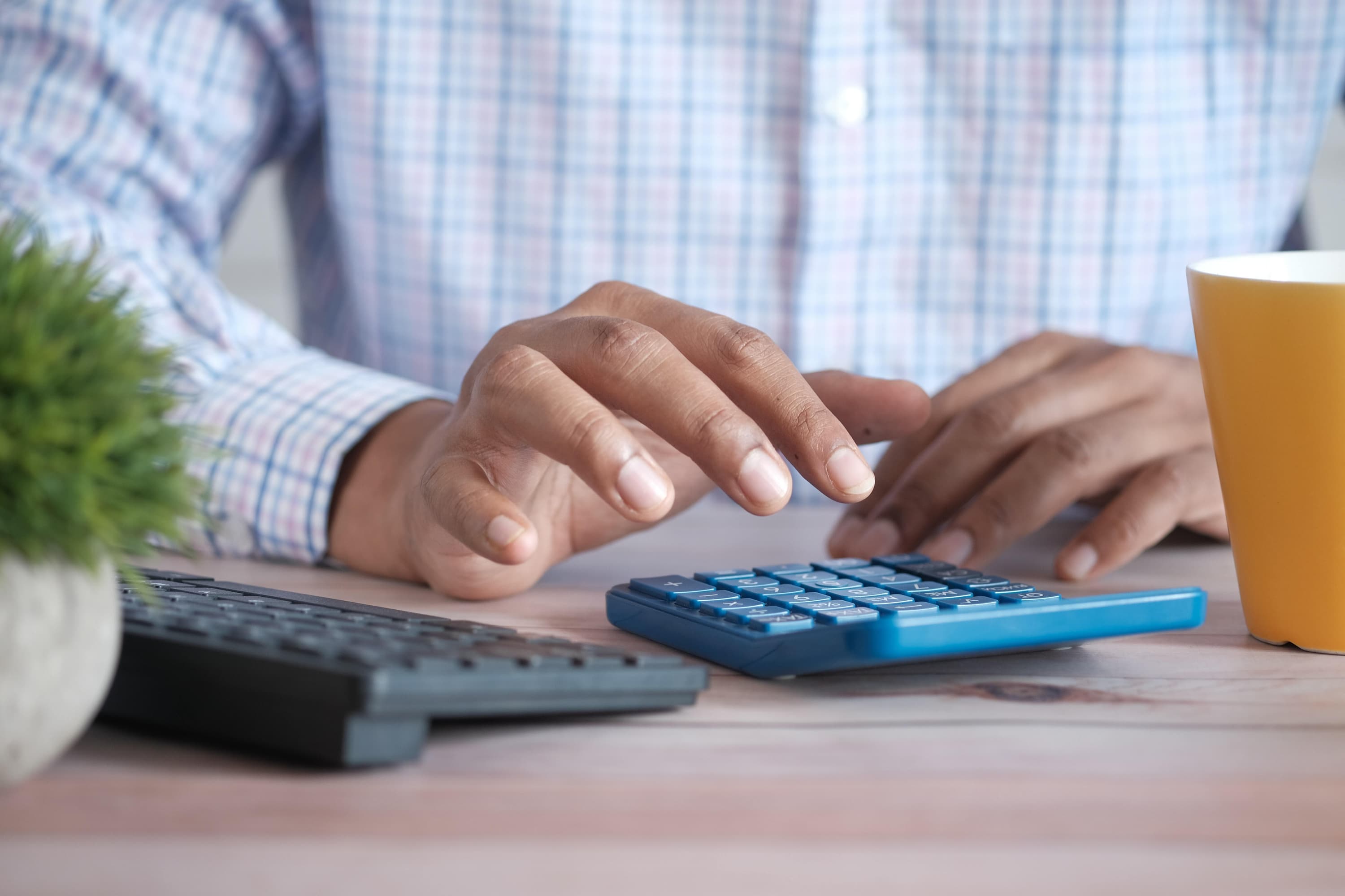 Person using a calculator at their desk