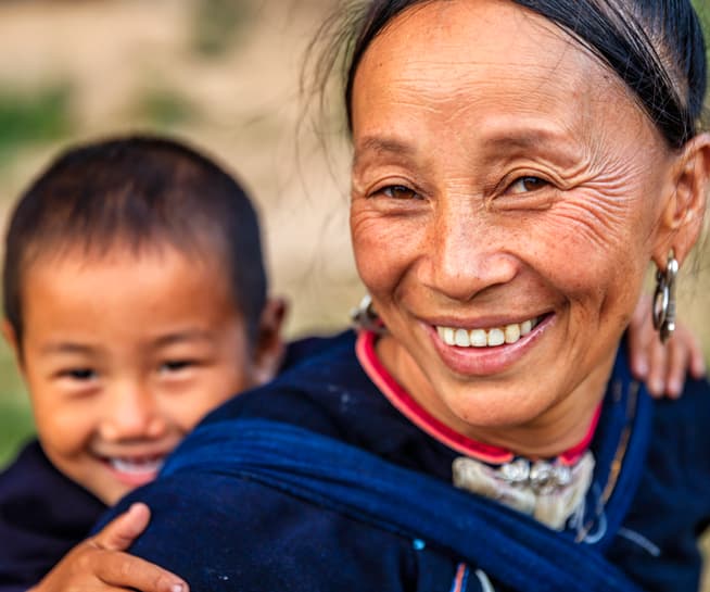 Smiling woman with baby on her back