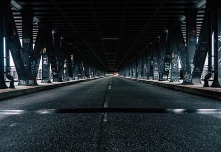 Empty black asphalt road under bridge 3605261